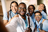 Cheerful medical students taking selfie and having fun at the university.