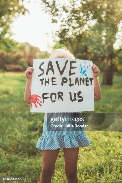 kids with posters protecting the planet. protest - world democracy stock pictures, royalty-free photos & images