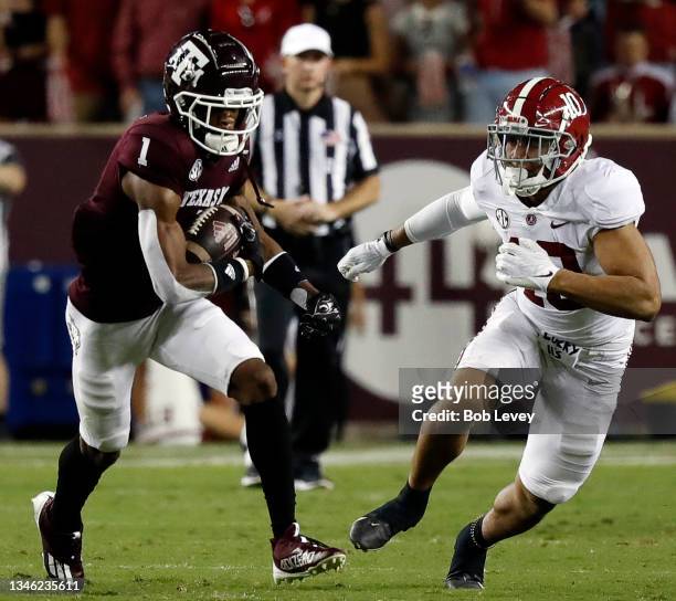 Demond Demas of the Texas A&M Aggies runs with the ball as Henry To'oTo'o of the Alabama Crimson Tide pursues at Kyle Field on October 09, 2021 in...