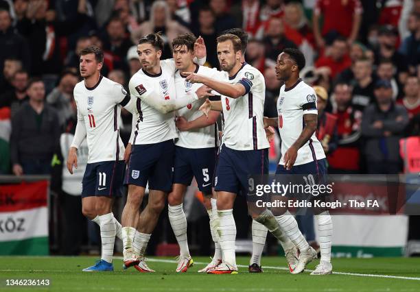 John Stones of England celebrates with teammates Raheem Sterling, Mason Mount, Jack Grealish and Harry Kane after scoring their team's first goal...