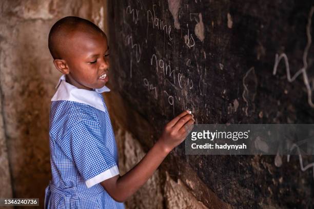 african little girl is learning english language, orphanage in kenya - kenyansk kultur bildbanksfoton och bilder