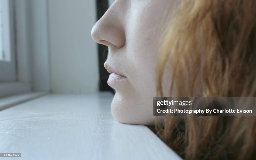 Woman looking out of window