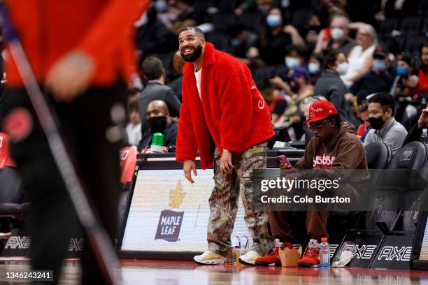 Drake attends a preseason NBA game between the Toronto Raptors and the Houston Rockets at Scotiabank Arena on October 11, 2021 in Toronto, Canada....