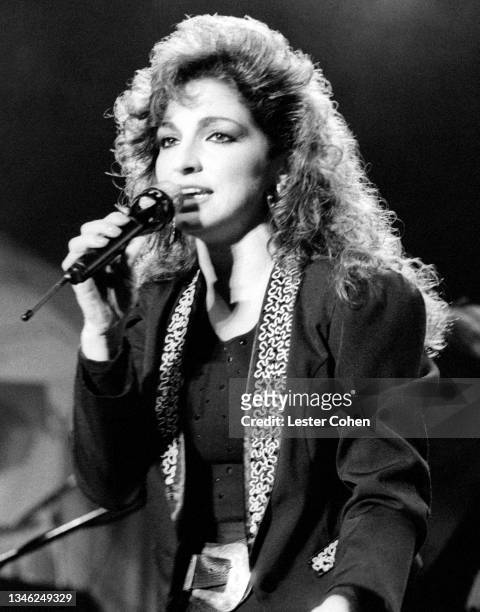 Cuban singer, songwriter, actress, and businesswoman Gloria Estefan, of the American band Gloria Estefan and the Miami Sound Machine, sings on stage...