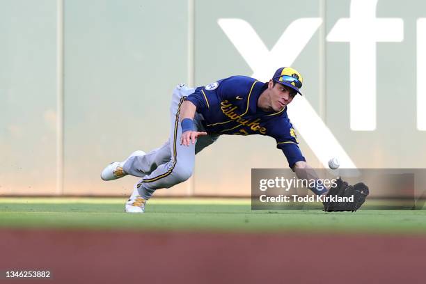 Christian Yelich of the Milwaukee Brewers unable to make a catch during the second inning against the Atlanta Braves in game four of the National...