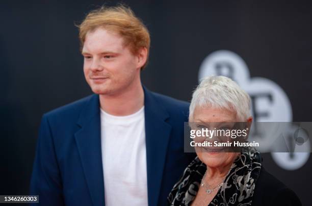 Dame Judi Dench and Sam Williams attend the "No Time To Die" World Premiere at Royal Albert Hall on September 28, 2021 in London, England.