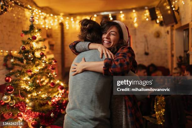 hugs feel even better on christmas - hug christmas stock pictures, royalty-free photos & images
