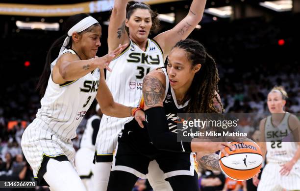Candace Parker of the Chicago Sky and Stefanie Dolson of the Chicago Sky defend Brittney Griner of the Phoenix Mercury in the first half at Footprint...