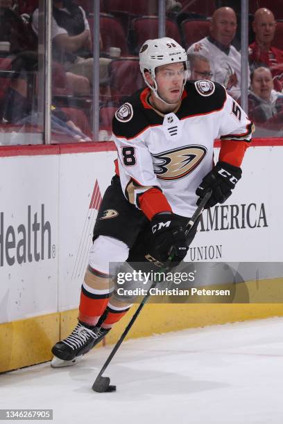 Brogan Rafferty of the Anaheim Ducks skates with the puck during the NHL game at Gila River Arena on October 02, 2021 in Glendale, Arizona. The...