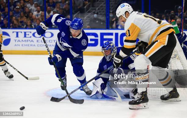 Andrei Vasilevskiy and Ross Colton of the Tampa Bay Lightning stop a shot from Brian Boyle of the Pittsburgh Penguins during the first period of a...