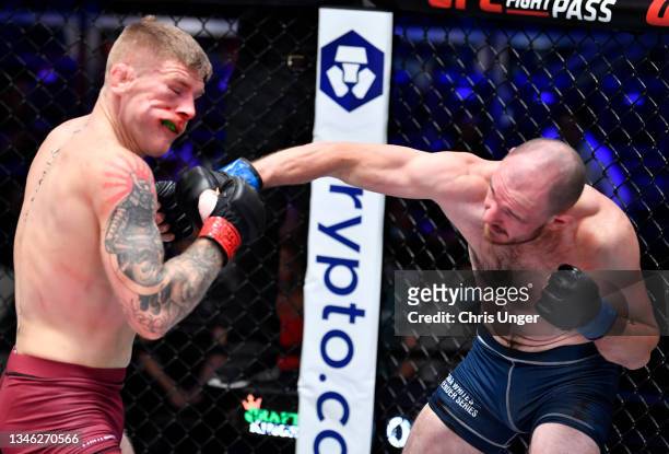 Viacheslav Borshchev punches Chris Duncan in a lightweight fight during Dana White's Contender Series season five, week seven at UFC APEX on October...