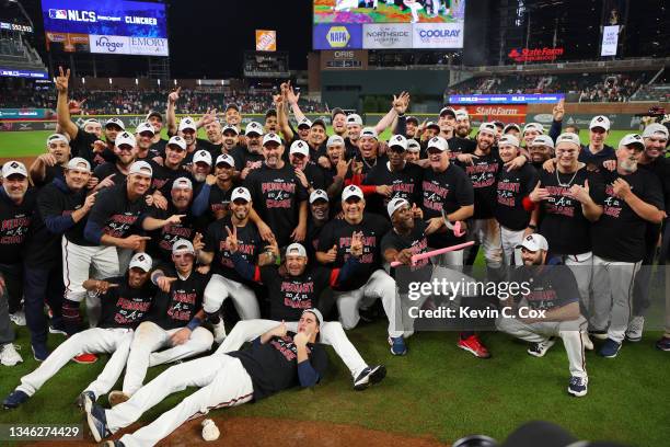 The Atlanta Braves pose for a photo after defeating the Milwaukee Brewers 5-4 in game four of the National League Division Series at Truist Park on...