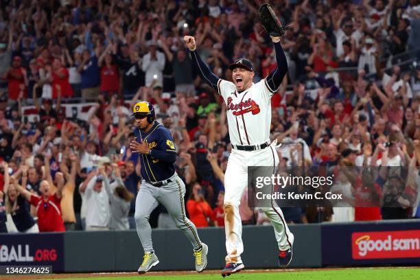 Freddie Freeman of the Atlanta Braves reacts after defeating the Milwaukee Brewers 5-4 in game four of the National League Division Series at Truist...