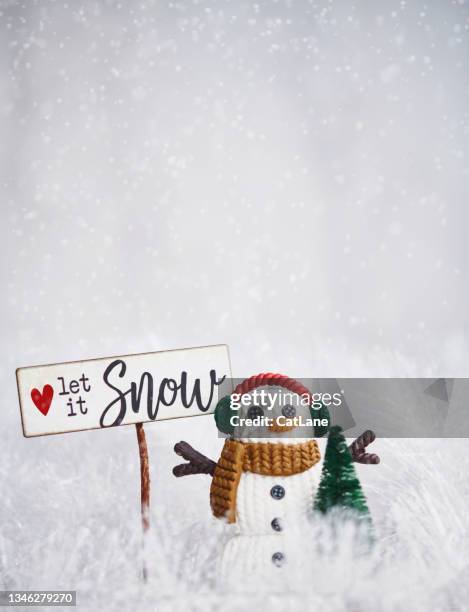 cute christmas snowman with let it snow sign in tinsel snow - let it snow 個照片及圖片檔