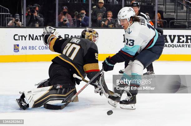 Robin Lehner of the Vegas Golden Knights makes a first-period save on Brandon Tanev of the Seattle Kraken during the first period of the Kraken's...