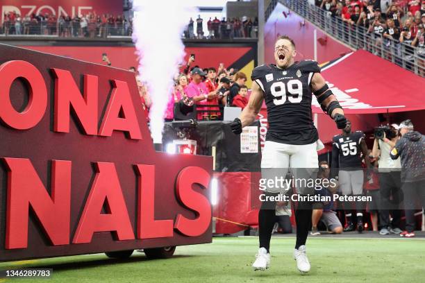 Defensive end J.J. Watt of the Arizona Cardinals runs onto the field before the NFL game at State Farm Stadium on October 10, 2021 in Glendale,...
