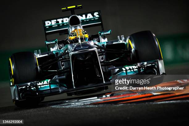 British Mercedes AMG Formula One team racing driver Lewis Hamilton driving his MGP W04 racing car at speed in during practice for the 2013 Abu Dhabi...