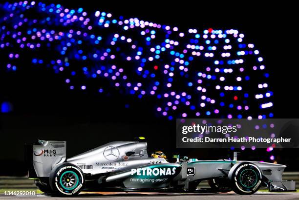 British Mercedes AMG Formula One team racing driver Lewis Hamilton driving his MGP W04 racing car past the multi coloured lights on the roof of the...