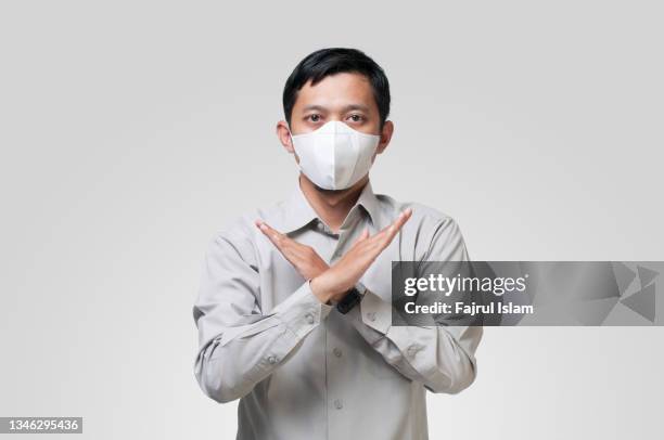 forbidden symbol with hand - surgical mask man stock pictures, royalty-free photos & images