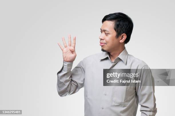 asian men showing number with his finger - one in four people stock pictures, royalty-free photos & images