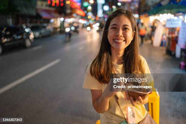 local daily life asian enjoy eating hoy jor traditional famaus food on plastic chair at yaowarat chinatown bangkok thailand - thai food stock pictures, royalty-free photos & images