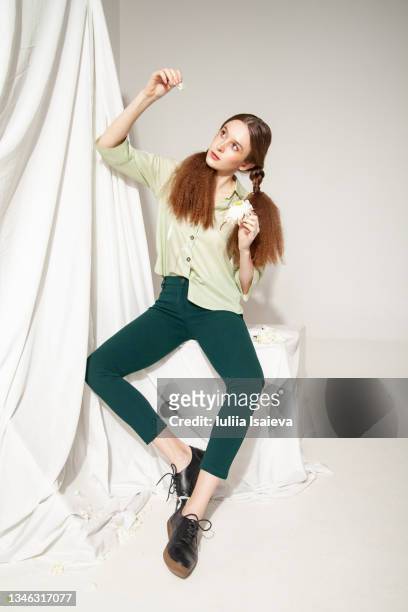 stylish woman with white flower - studio shot lonely woman stock pictures, royalty-free photos & images