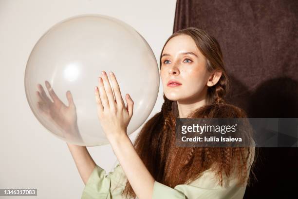 redhair young woman with makeup holding balloon - transparent blouse stock pictures, royalty-free photos & images