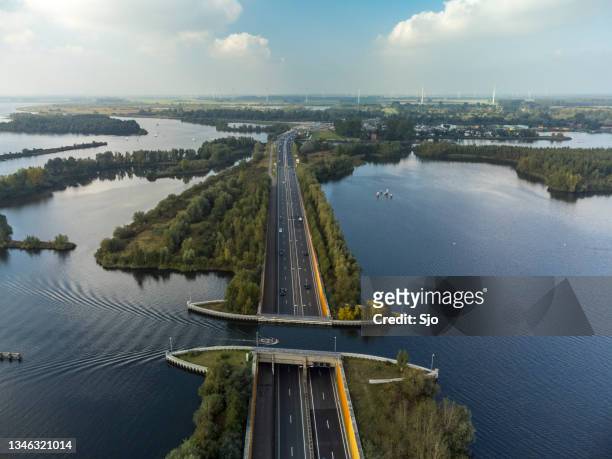 aquaduct veluwemeer in the veluwe lake with a boat sailing in the canal - aqueduct stockfoto's en -beelden