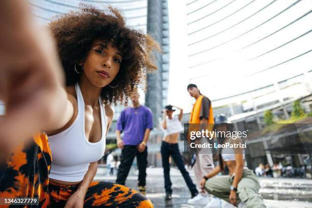 tanzgruppe junger männer und frauen, die in den straßen der stadt auftreten - hip hop dance stock-fotos und bilder