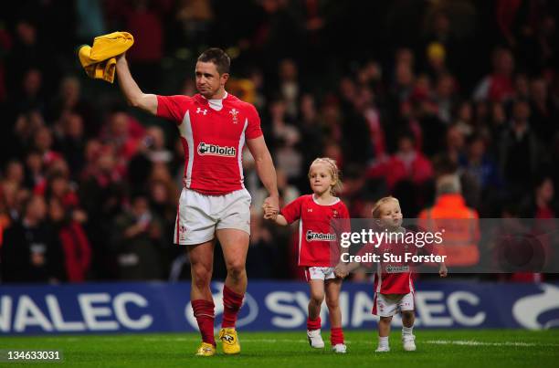 Wales wing Shane Williams waves to the crowd with his children on his lap of honour after the Test match between Wales and the Australian Wallabies...