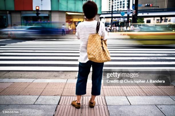 woman waiting to cross street - ginza crossing stock pictures, royalty-free photos & images