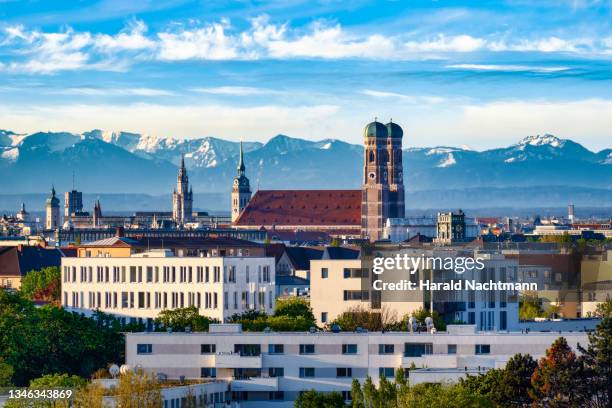 cityscape of historical center with cathedral against mountain range, munich, bavaria, germany - catedral de múnich fotografías e imágenes de stock