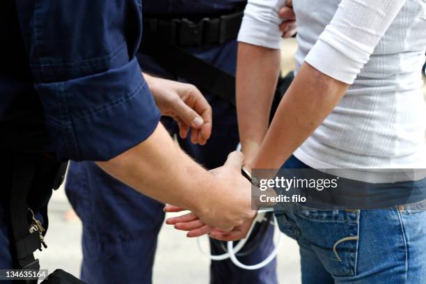 handcuffed - handcuffs stock pictures, royalty-free photos & images