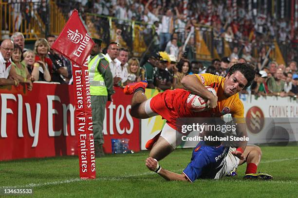 Mat Turner of England scores a try despite the challenge from Terry Bouhraoua of France during the Final match between England and France on Day...