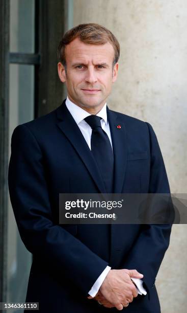 French President Emmanuel Macron waits for Tajikistan President Emomali Rahmon prior to a working lunch at the Elysee Palace on October 13, 2021 in...