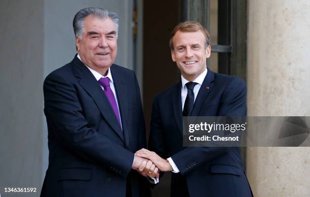 French President Emmanuel Macron welcomes Tajikistan President Emomali Rahmon prior to a working lunch at the Elysee Palace on October 13, 2021 in...