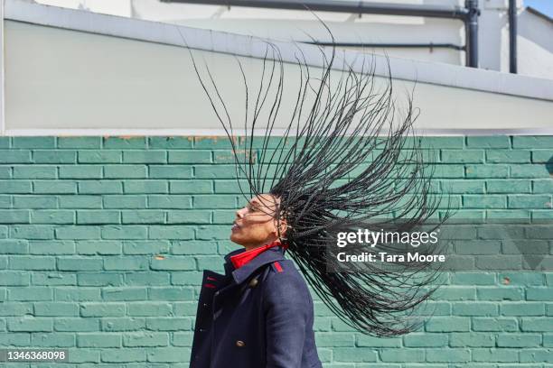 portrait of woman tossing her hair. - scuotere i capelli foto e immagini stock