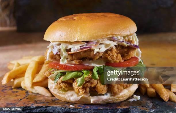 the ultimate double spicy crispy fried chicken burger - coleslaw stock pictures, royalty-free photos & images