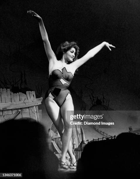 Model and actress Julie Newmar performs during the Broadway production of "Li'l Abner" in her role as "Stupefyin' Jones" in November, 1956 at the St....