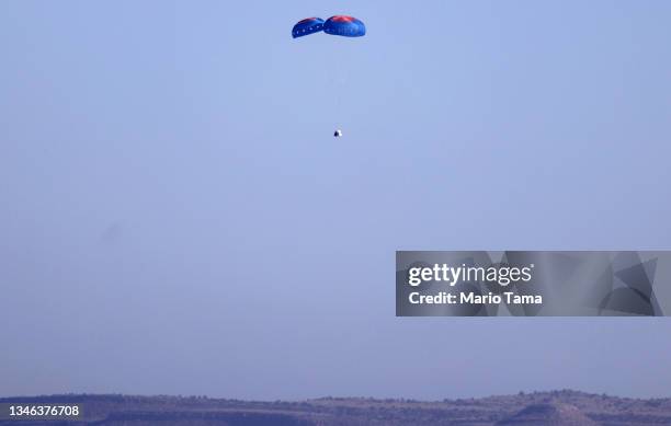 Blue Origin’s New Shepard crew capsule descends on the end of its parachute system carrying 90-year-old Star Trek actor William Shatner and three...