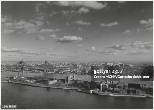 View of the East River from Manhattan showing Roosevelt Island , the Queensboro Bridge and Queens. Blackwell's Island Penitentiary can be seen ....