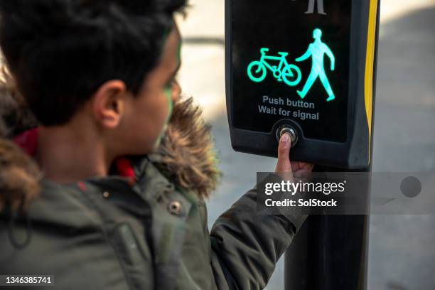 pressing the button at a pedestrian crossing - crossing stock pictures, royalty-free photos & images