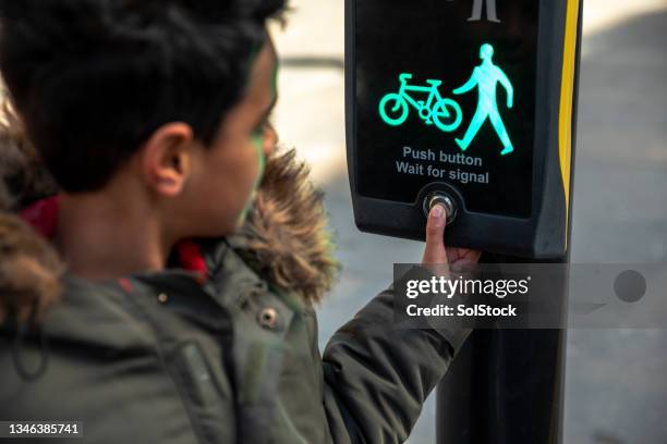 pressing the button at a pedestrian crossing - crosswalk stock pictures, royalty-free photos & images