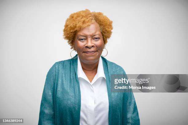african american senior woman smiling against white background - senior woman portrait photos et images de collection