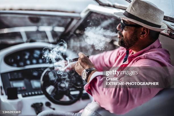 attractive businessman with a cigar - luxury watches stock pictures, royalty-free photos & images