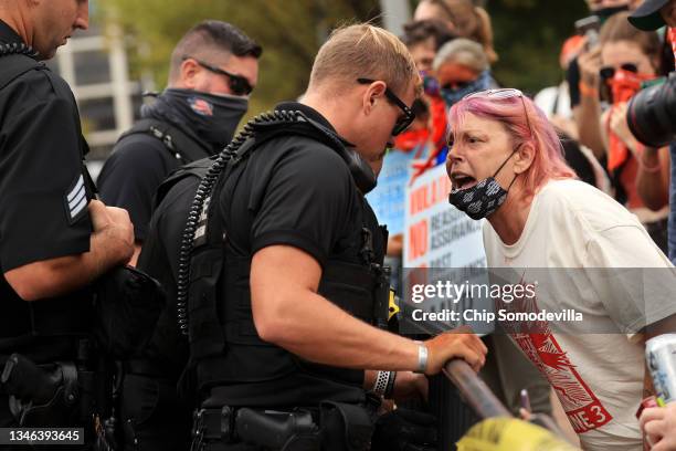 Demonstrator yells in the faces of Secret Service Uniform Division officers, calling them 'Nazis,' during a rally outside the White House during the...