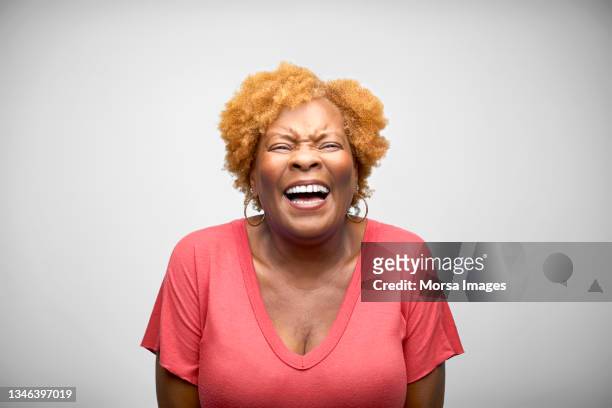 mature african american woman laughing against white background - woman laughing stock pictures, royalty-free photos & images