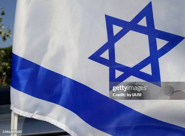 close-up of the israeli flag with star of david with some wind - israeli flag stock pictures, royalty-free photos & images