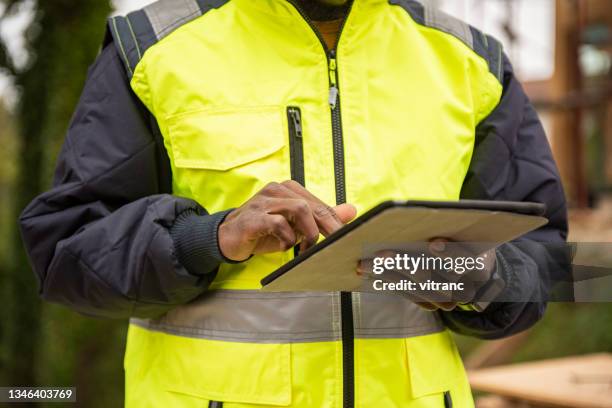 male engineer using digital tablet at construction site - civil engineer stock pictures, royalty-free photos & images