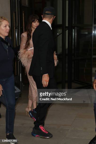 Chris Martin and Dakota Johnson seen leaving The Corinthia Hotel ahead of the "The Lost Daughter" UK Premiere during the 65th BFI London Film...